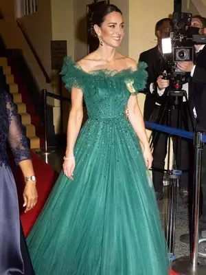 Kate Middleton wearing a green off-the-shoulder gown with sparkly embellishments