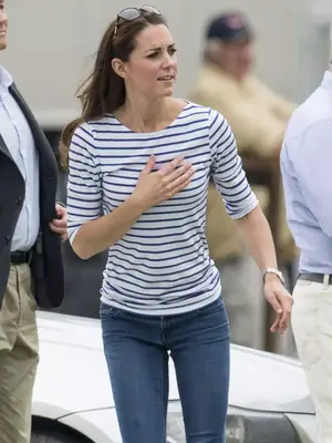 Kate Middleton wears a blue and white Breton stripe top, jeans, and sunglasses on head