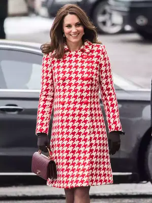 Kate Middleton wearing a red and white dress with gloves and a dark purple Chanel purse 