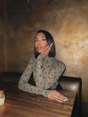 Tatiana Elizabeth posing for a photo while wearing a sheer top