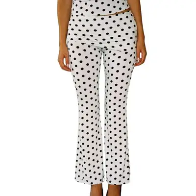 Model wearing white pants with black polka dots