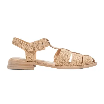 Close-up of person wearing woven fisherman sandals and black drawstring bucket bag