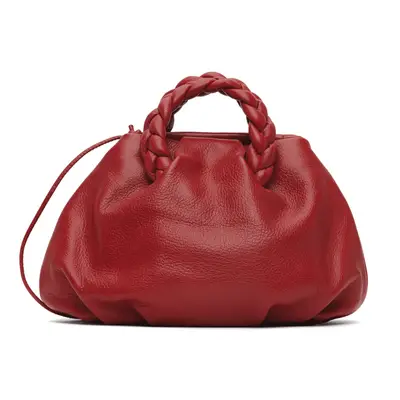 Nnenna Echem wearing a red strapless dress and holding a red clutch handbag