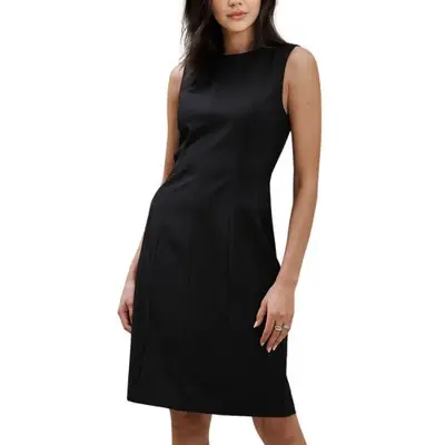 Model wearing a mid-length structured black dress