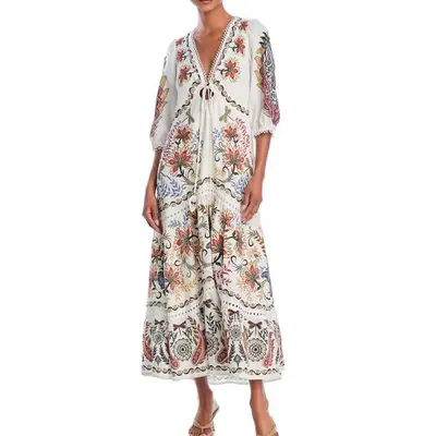 model wearing a white caftan with a multicolor floral print
