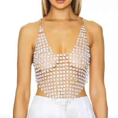 Camila Coelho Monica Shell Top on model paired with white bottoms