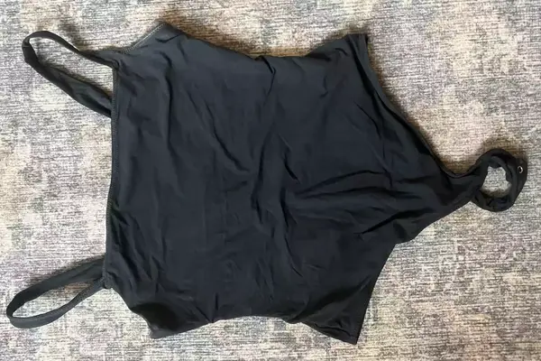 The Skims Fits Everybody Square Neck Bodysuit on a colorful rug