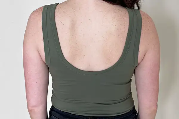 The back of a person wearing the Nuuds Seamless Scoop Tank Bodysuit