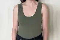 A person wears the Nuuds Seamless Scoop Tank Bodysuit