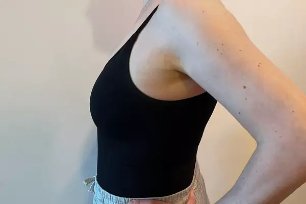 A side view of a person wearing the Shapermint Essentials All Day Every Day Scoop Neck Bodysuit