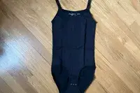 The Shapermint Essentials All Day Every Day Scoop Neck Bodysuit on a wooden floor