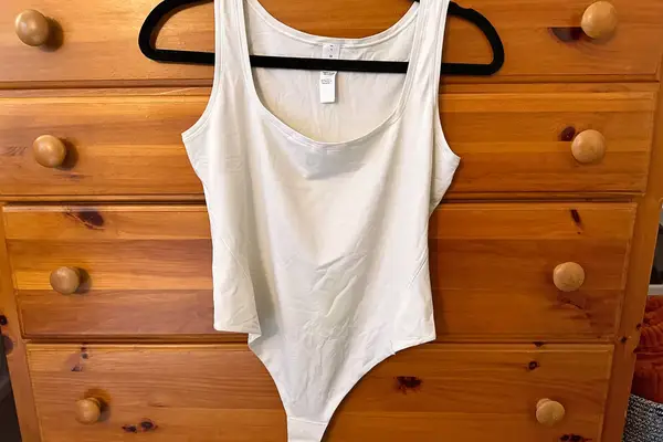 The lululemon Wundermost Ultra-Soft Nulu Square-Neck Sleeveless Bodysuit hangs from a hanger