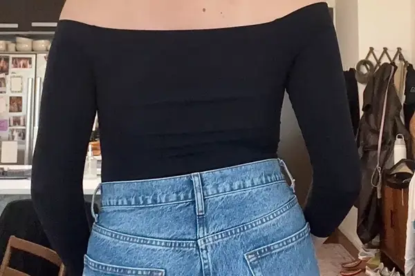 A person wearing the Commando Ballet Off-Shoulder Bodysuit from the back