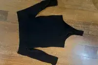 The Commando Ballet Off-Shoulder Bodysuit on a wooden floor