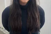 A person wears the Spanx Suit Yourself Long Sleeve Turtleneck Thong Bodysuit