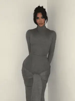 Kim Kardashian wearing a gray turtlenecked sweater dress