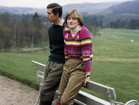 Princess Diana wears a pink striped sweater, green corduroy trousers, and white turtleneck