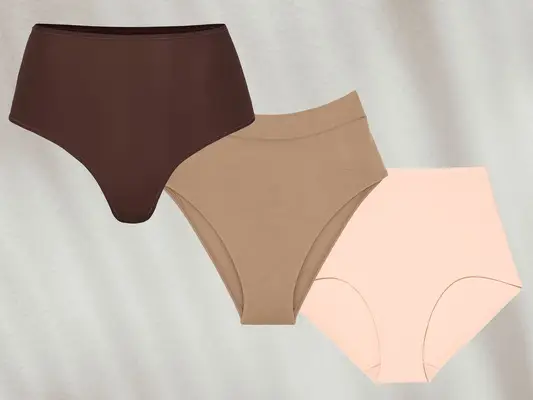 Three pairs of high-waisted underwear in brown, beige, and nude against a grey background