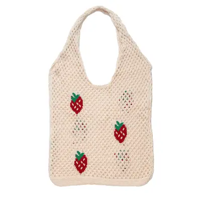 A model wearing a tan crochet maxi dress 