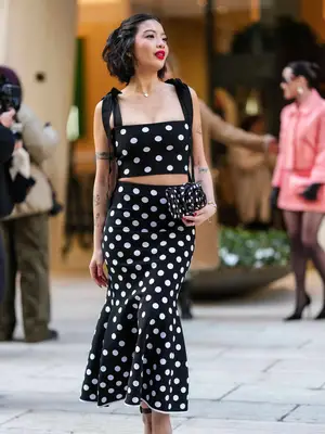 model wearing a polka dot set with matching bag