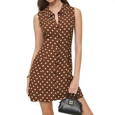 model wearing a short brown polka dot Reformation dress