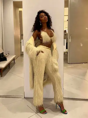 Tatiana Elizabeth wearing a matching fringed yellow set