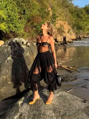 Izzi wearing sheer lace top and lace bloomers with yellow sandals