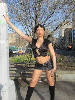 Person wearing tie-front top, micro-mini skirt, and thigh high boots