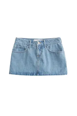 Bella Hadid wearing a denim skirt, white tee, and ballet flats.