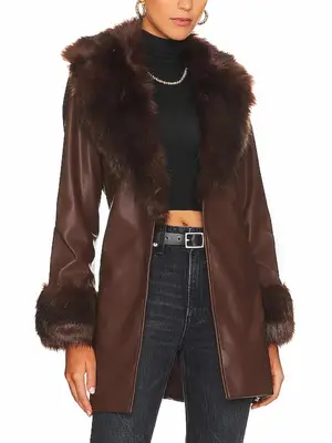 Model wearing a leather jacket with fur details at the collar and sleeves
