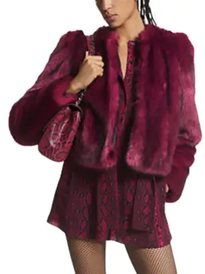 Model wearing a dark fuchsia cropped jacket