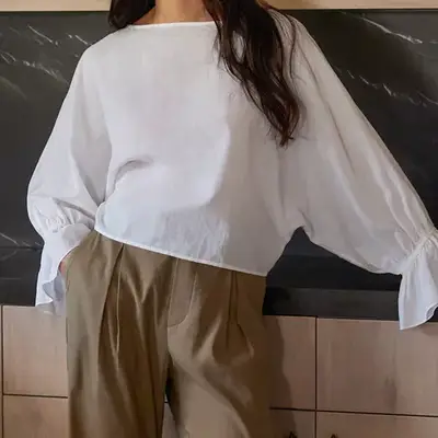 Jenni Kayne Cape Blouse in ivory on model styled with khaki pants