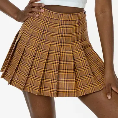 model wearing yellow plaid pleated tennis skirt