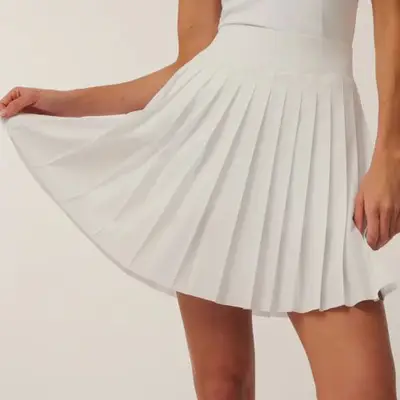 model wearing white pleated tennis skirt