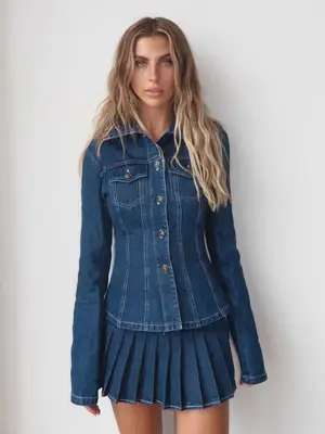 Paige Lorenze wearing denim long sleeve top and denim pleated tennis skirt