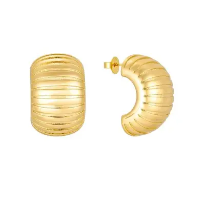 gold thick earrings in half hoop against plain background
