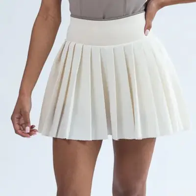 model wearing white pleated tennis skirt