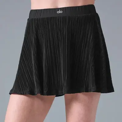 model wearing black workout tennis skirt