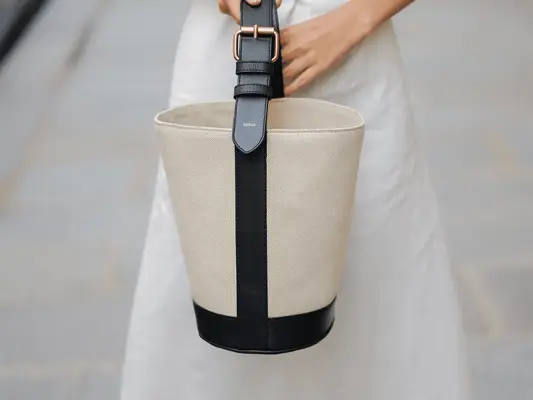 canvas and black bucket bag with gold buckle