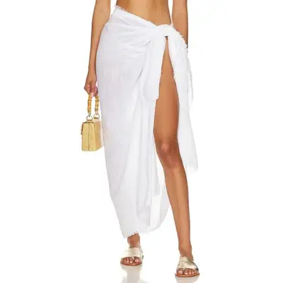 Seafolly Textured Beach Wrap in white on model styled with top handle bag and gold sandals