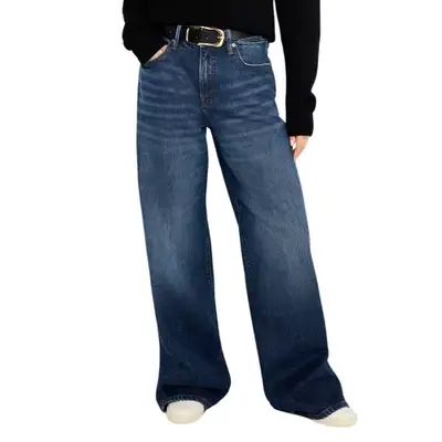 person wearing dark-wash jeans