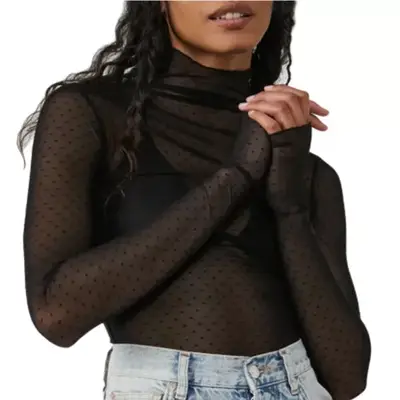 person wearing a sheer swiss dot top