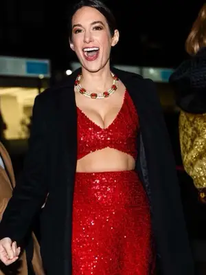 Savannah Engel wears a red sequined top and skirt set with black blazer and red gem necklace