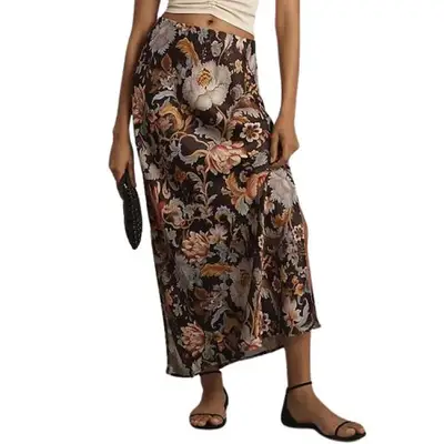 person wearing a neutral floral slip skirt, minimalist brown sandals, and small handbag