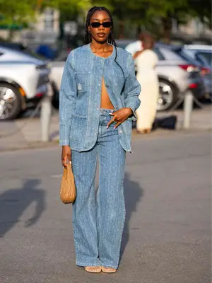 Woman wearing a denim jacket and jeans