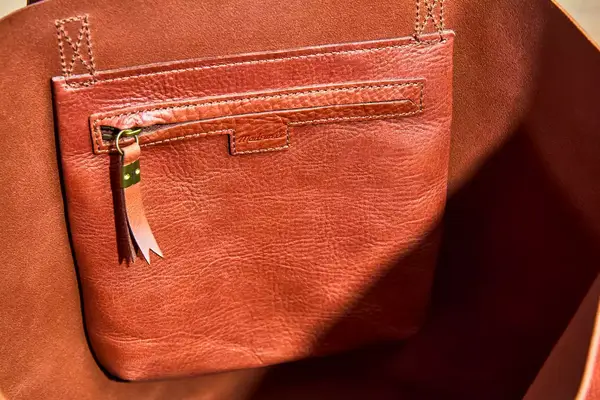 A close up of the zipper pocket in the Madewell The Transport Tote
