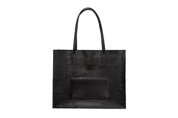 The Madewell The Transport Tote sitting on a wooden table