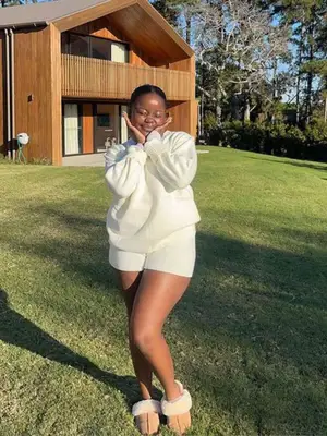 person wearing a cream lounge set with slippers