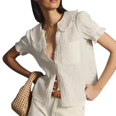 model wearing a button-down blouse