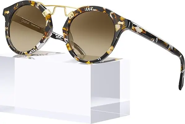 Sunglasses with a marbled brown, black, and tan frame. 